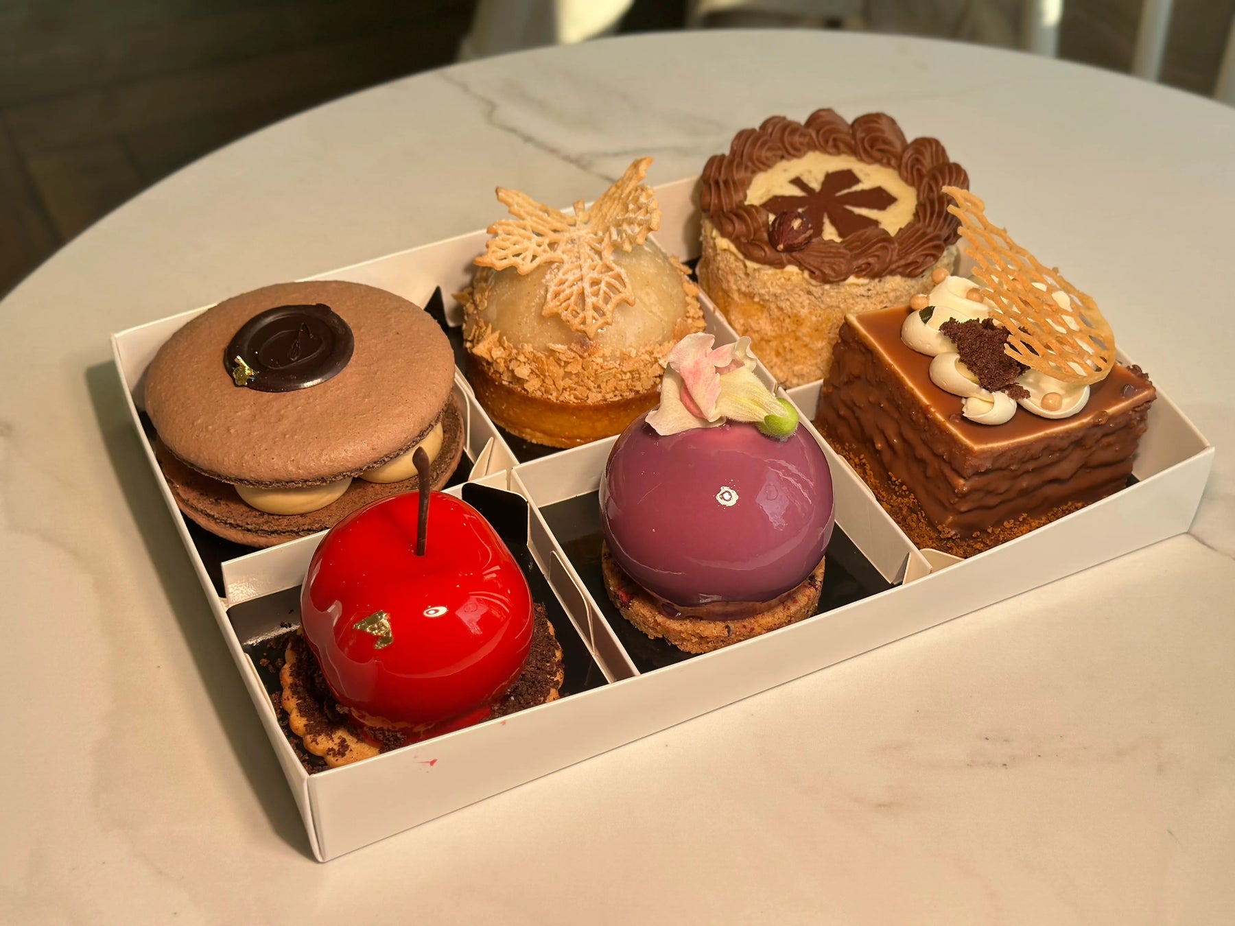 assorted dessert set with multiple individual desserts arranged in gift box, tasting desserts box from bakery in Wrocław