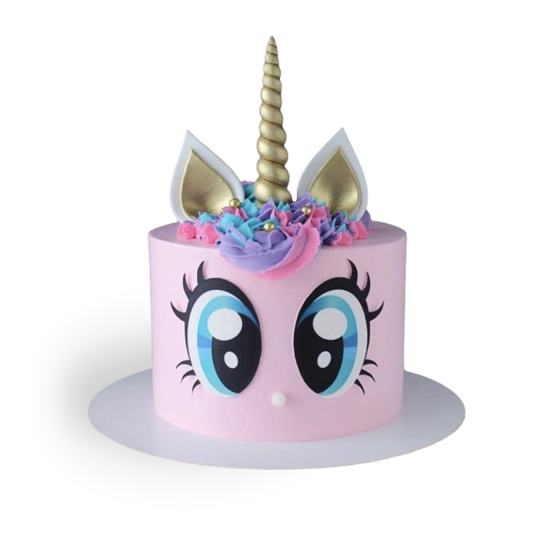 Sculpted unicorn head birthday cake featuring painted eyelashes, sugar fondant gold ears, and a colorful pink and blue cream mane by Dessert Boutique.