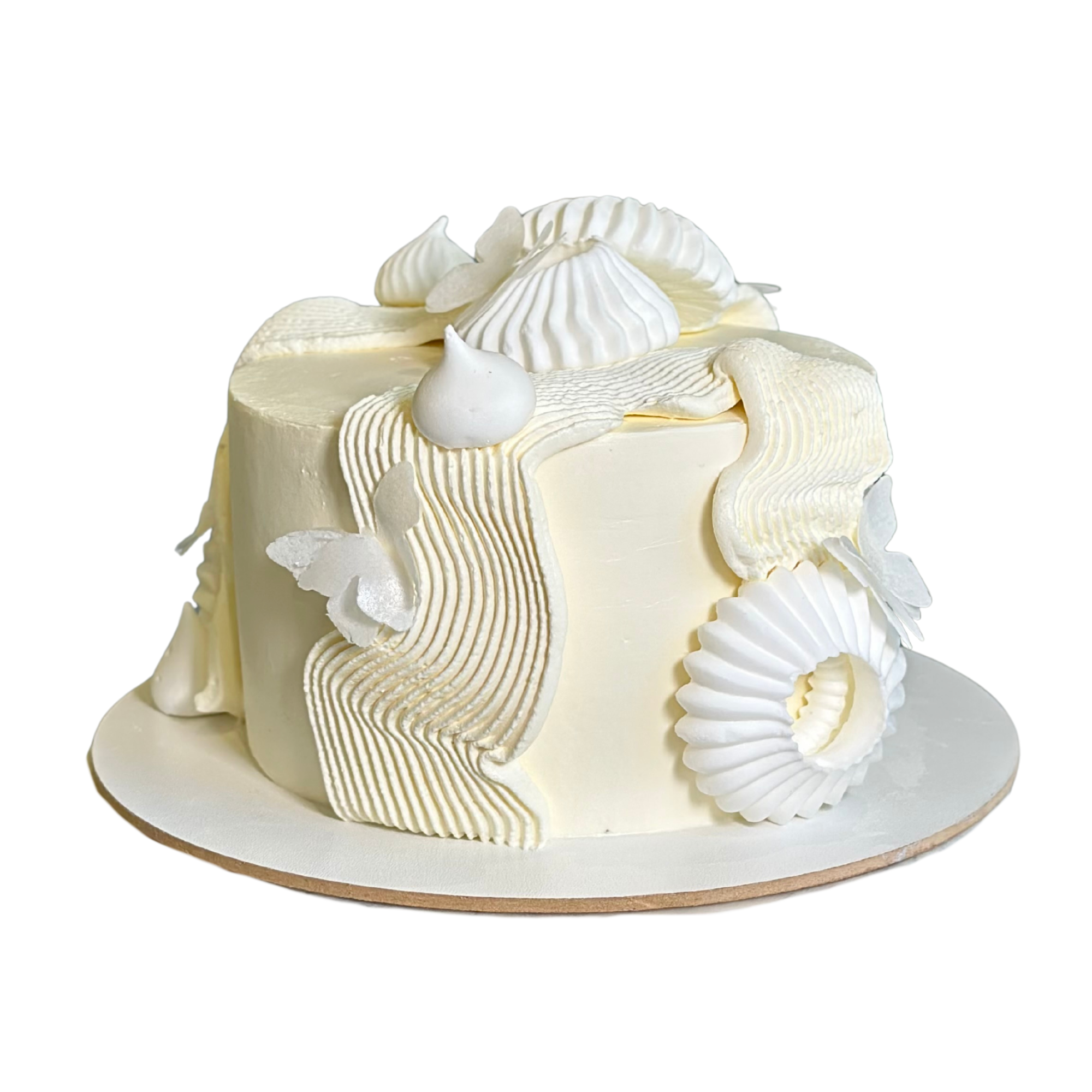 Cake with textured wave piping and white butterfly accents.