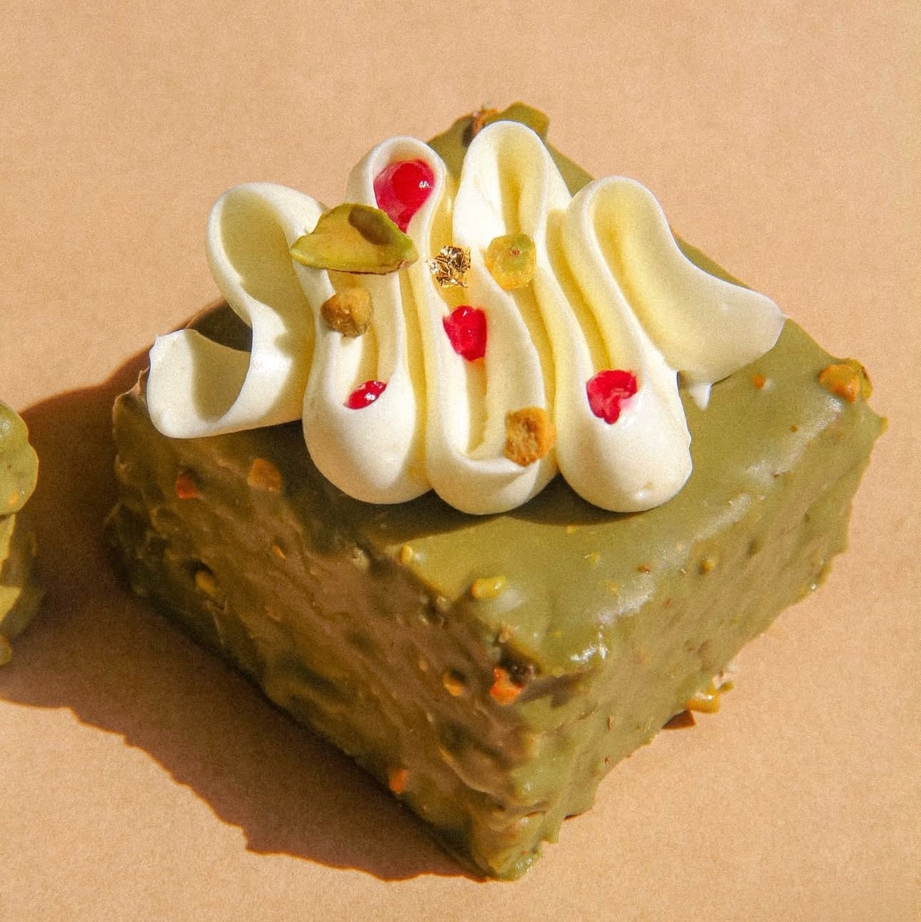 Cake slice with pistachio cream and rasberry layers, local delivery 