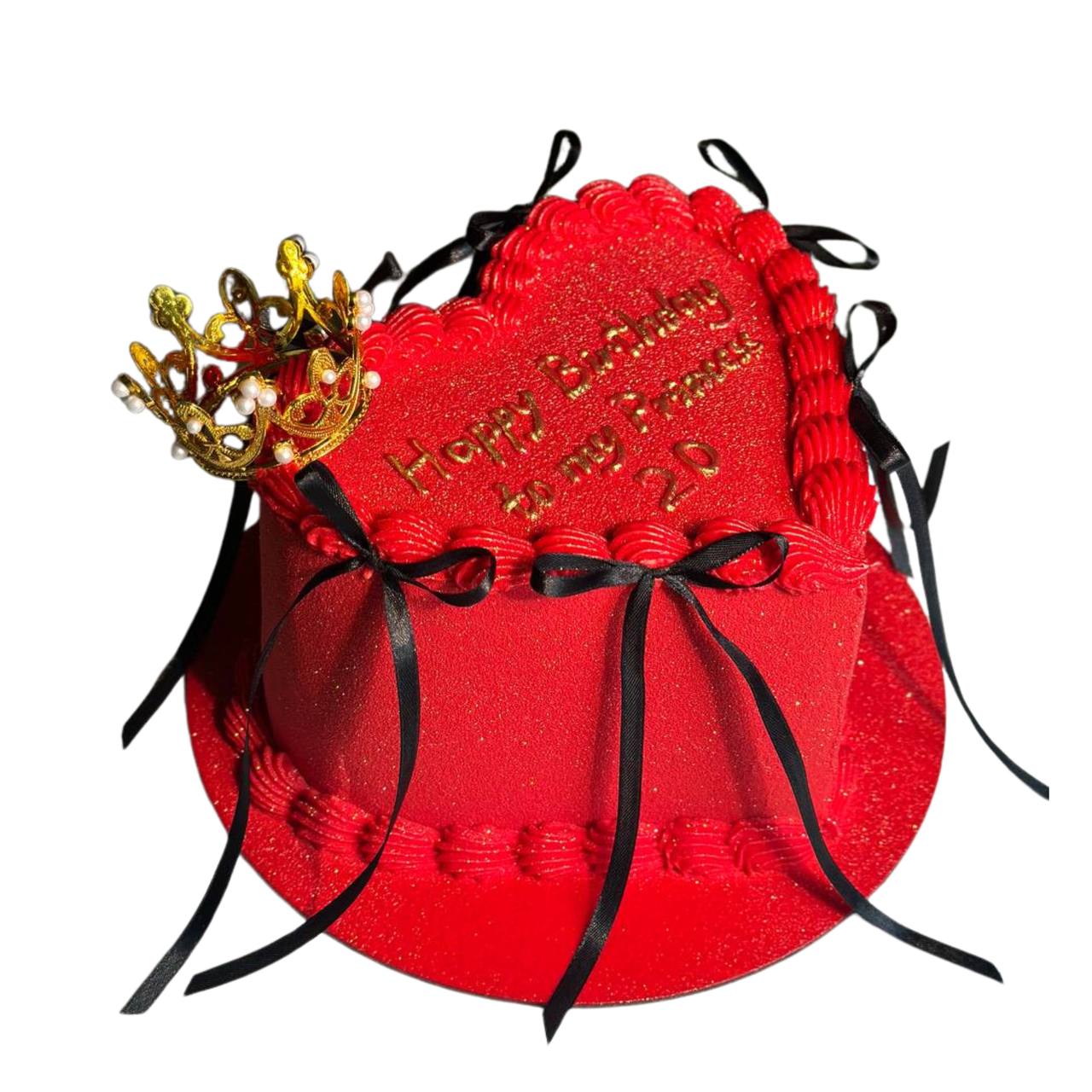 Red heart shaped cake with black ribbon bows, a gold princess crown, and custom birthday lettering by Dessert Boutique.