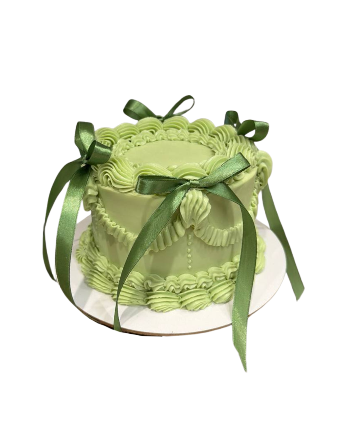 Elegant sage green vintage styled cake decorated with traditional piped royal icing swags and real green satin ribbons by Dessert Boutique.