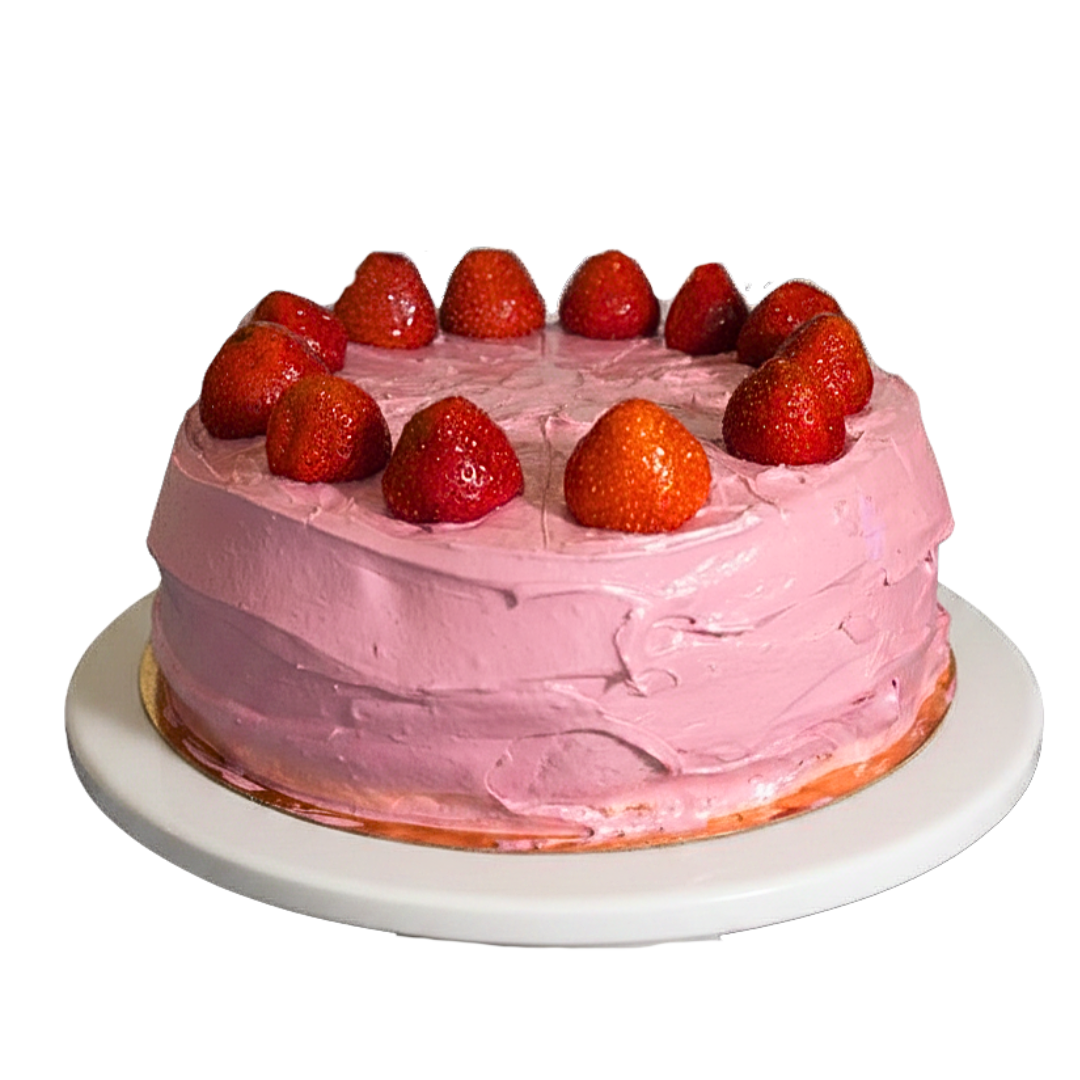 Round pink frosted celebration cake featuring layered retro buttercream ruffles and fresh strawberries on top by Dessert Boutiqu