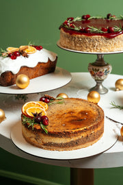 mini poppy seed cheesecake with lightly baked top, almond crust base and citrus garnish on christmas table 